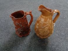 Two antique glazed pottery embossed jugs