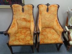 A pair of early twentieth century carved beech framed armchairs in orange upholstery
