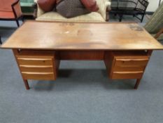 A mid century continental teak low desk fitted with six drawers