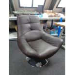 A brown leather armchair on swivel base