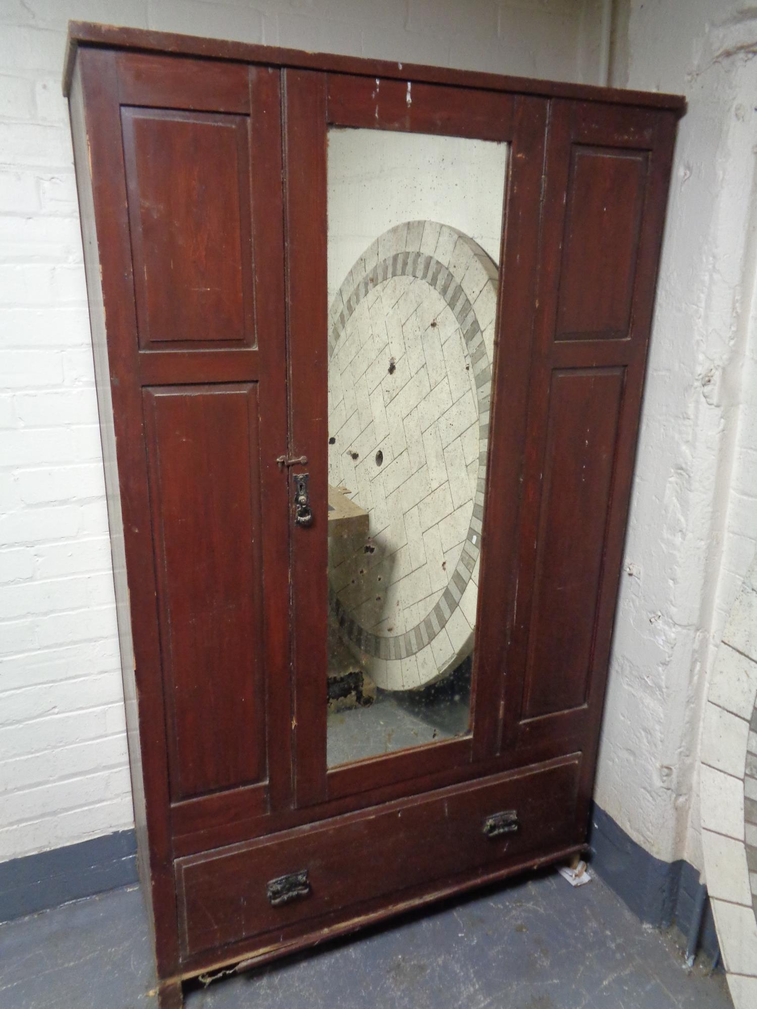 An Edwardian stained pine mirror door wardrobe (as found)