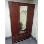 An Edwardian stained pine mirror door wardrobe (as found)