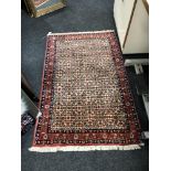 A Persian rug, 144cm by 89cm.