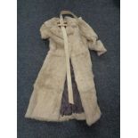 A white mink fur coat with leather belt