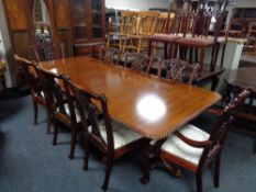 A reproduction Victorian style twin pedestal dining table with two leaves and eight Hepplewhite