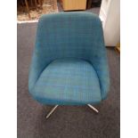 A twentieth century swivel chair upholstered in purple turquoise fabric on chrome swivel base