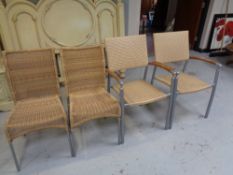 A pair of metal framed rattan conservatory armchairs and pair of similar chairs