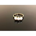 A 14ct gold three pearl ring,