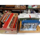 A twentieth century Newhome electric sewing machine in case together with a box of vintage board
