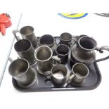 A tray of antique pewter items, tankards,