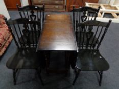 An oak drop leaf kitchen table and four chairs