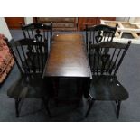 An oak drop leaf kitchen table and four chairs