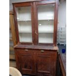 An antique glazed cabinet on cupboard base