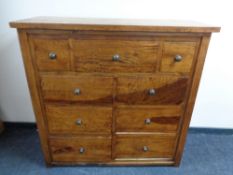 An Eastern hardwood nine drawer chest