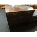 A George III mahogany five drawer chest with brass drop handles on bracket feet