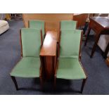 A twentieth century narrow teak drop leaf table together with a set of four teak dining chairs