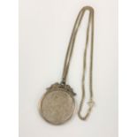 A sterling silver necklace with silver mounted coin pendant