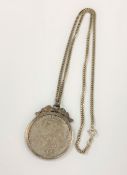 A sterling silver necklace with silver mounted coin pendant