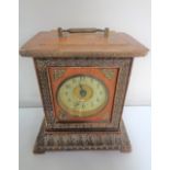 A late nineteenth century Junghans mantel clock with brass and enamelled dial