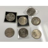A collection of coins to include Austrian Theresa Thaler coin, British Crowns, 1935 etc.