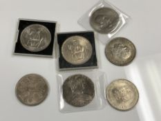 A collection of coins to include Austrian Theresa Thaler coin, British Crowns, 1935 etc.