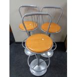 A set of three contemporary pine seated metal framed bar stools