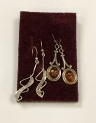 A pair of silver and amber earrings, together with another pair.