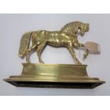A brass door stop in the form of a horse