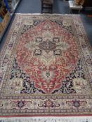 A fringed woolen Persian carpet