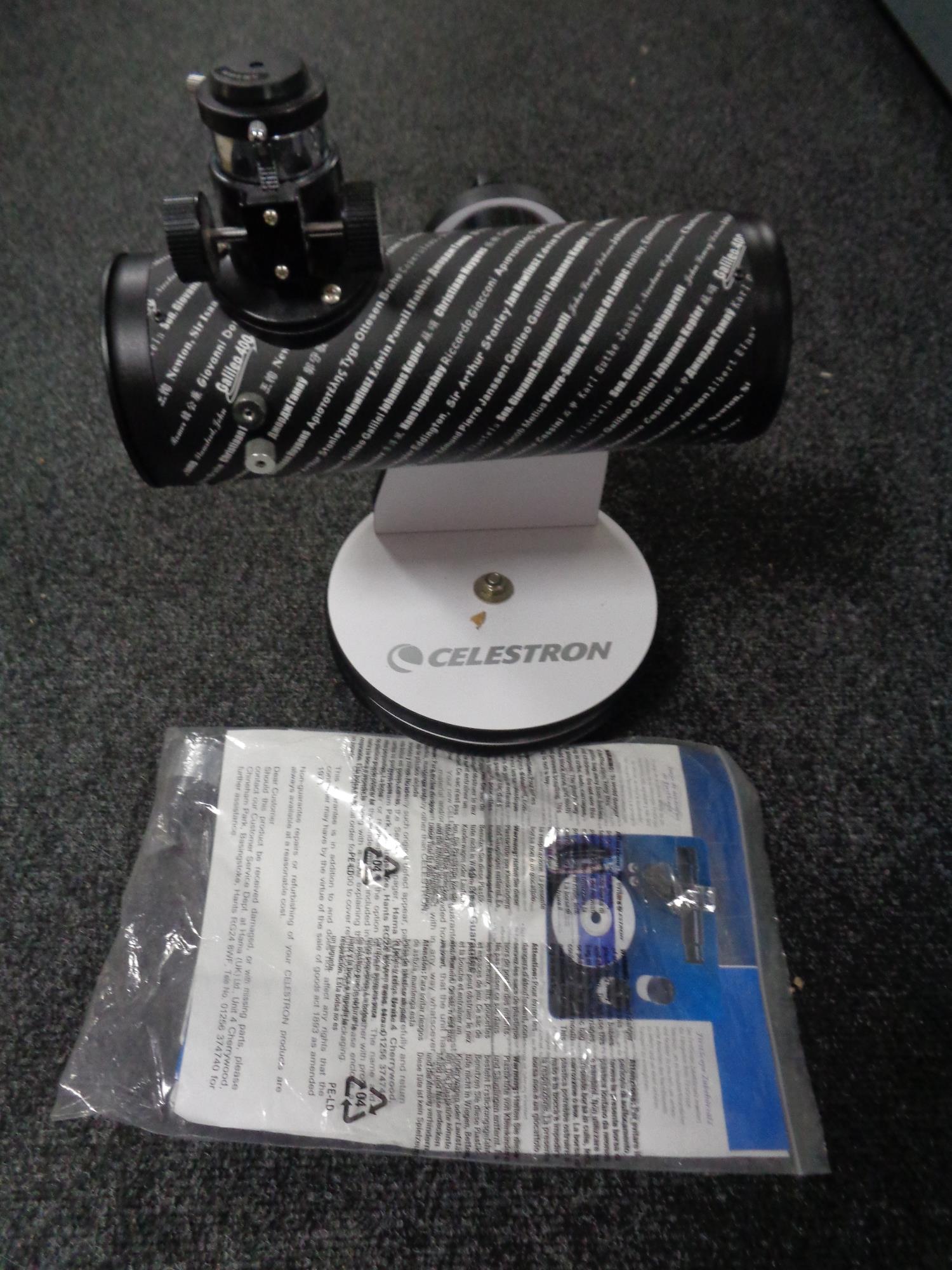 A Celestron 21024 bench top telescope with instructions and interchangeable lens