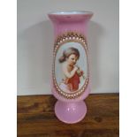 A Victorian pink glass vase with hand painted panel depicting girl with flute