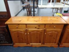 A pine triple door sideboard fitted with three drawers (af)