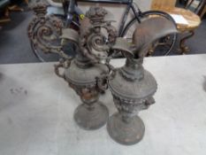 A pair of antique metal ewers