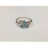 A silver dress ring set with blue stones,