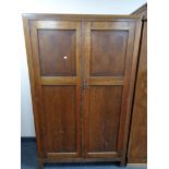 A 1930's double door oak gentleman's wardrobe