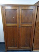 A 1930's double door oak gentleman's wardrobe