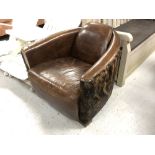A contemporary brown leather and cow hide armchair