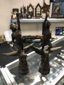 A pair of Spelter figures - Man and Lady riding eagles on wooden bases