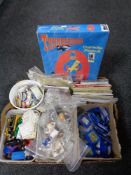 A box of tea cards and albums, vintage badges, die cast vehicles, tin badges,