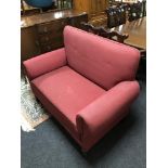 An Edwardian two seater settee in red fabric