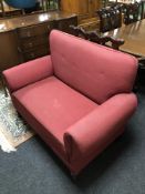 An Edwardian two seater settee in red fabric