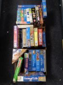 Three boxes of board games and jigsaws