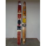 A pair of Freyrie water skis together with a wooden solo ski