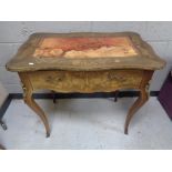 A late 19th century French inlaid walnut writing table fitted with a drawer with gilt metal mounts,