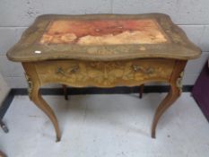 A late 19th century French inlaid walnut writing table fitted with a drawer with gilt metal mounts,