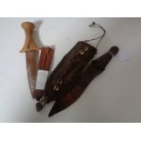 Two African knives, one with carved 'head' terminal.