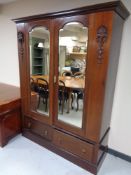 A Victorian mahogany double mirrored wardrobe fitted with two drawers