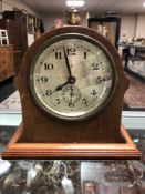 An Edwardian mahogany and pine mantel clock with silvered dial and key