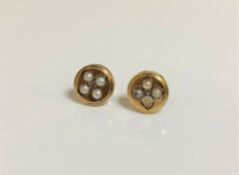 A pair of antique pearl earrings in yellow metal