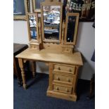 A pine dressing table fitted with three drawers and triple mirror